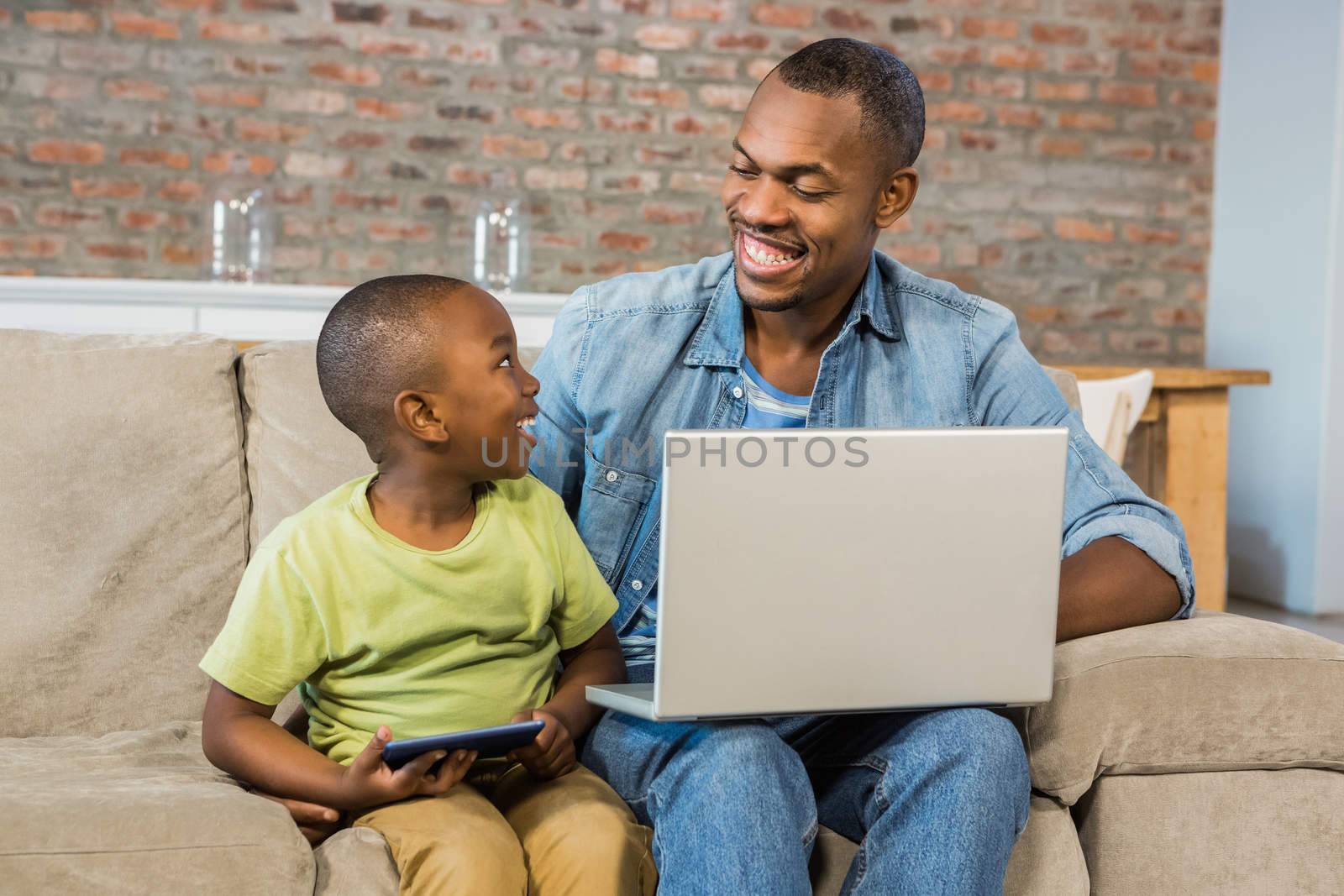 Happy family using technology together in living room