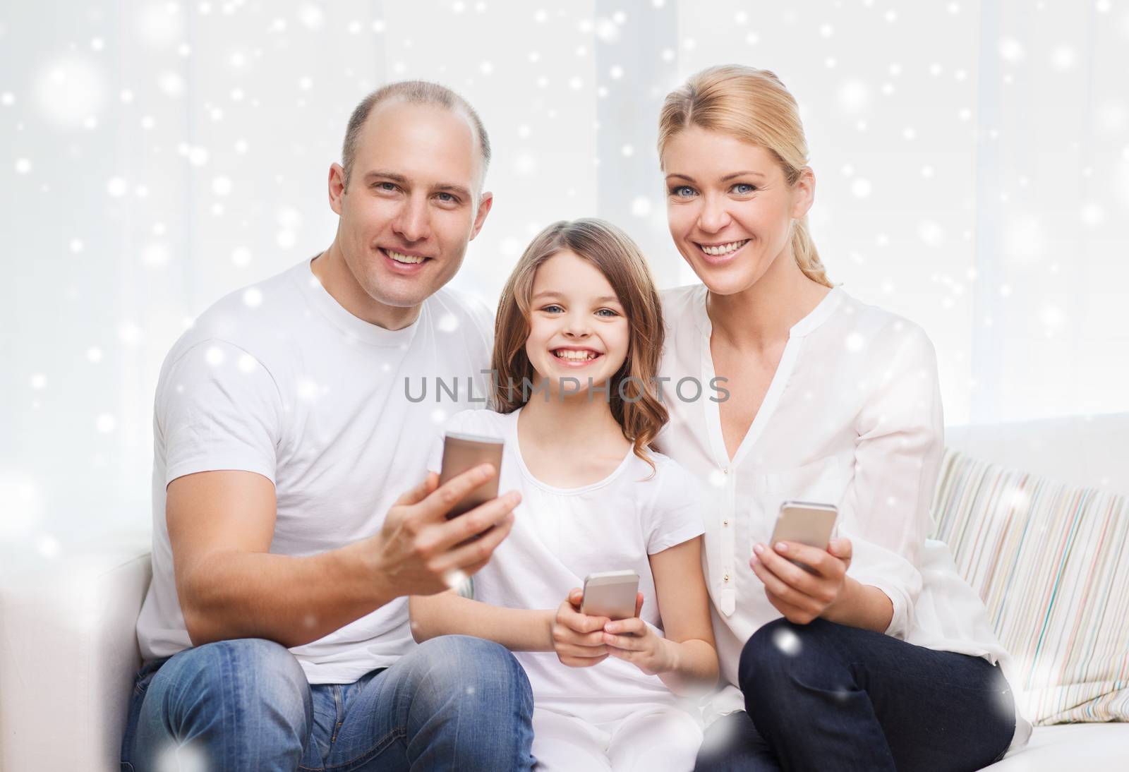 happy family with smartphones at home by dolgachov