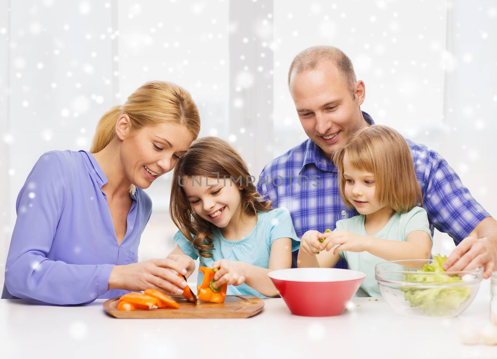 happy family with two kids making dinner at home by dolgachov