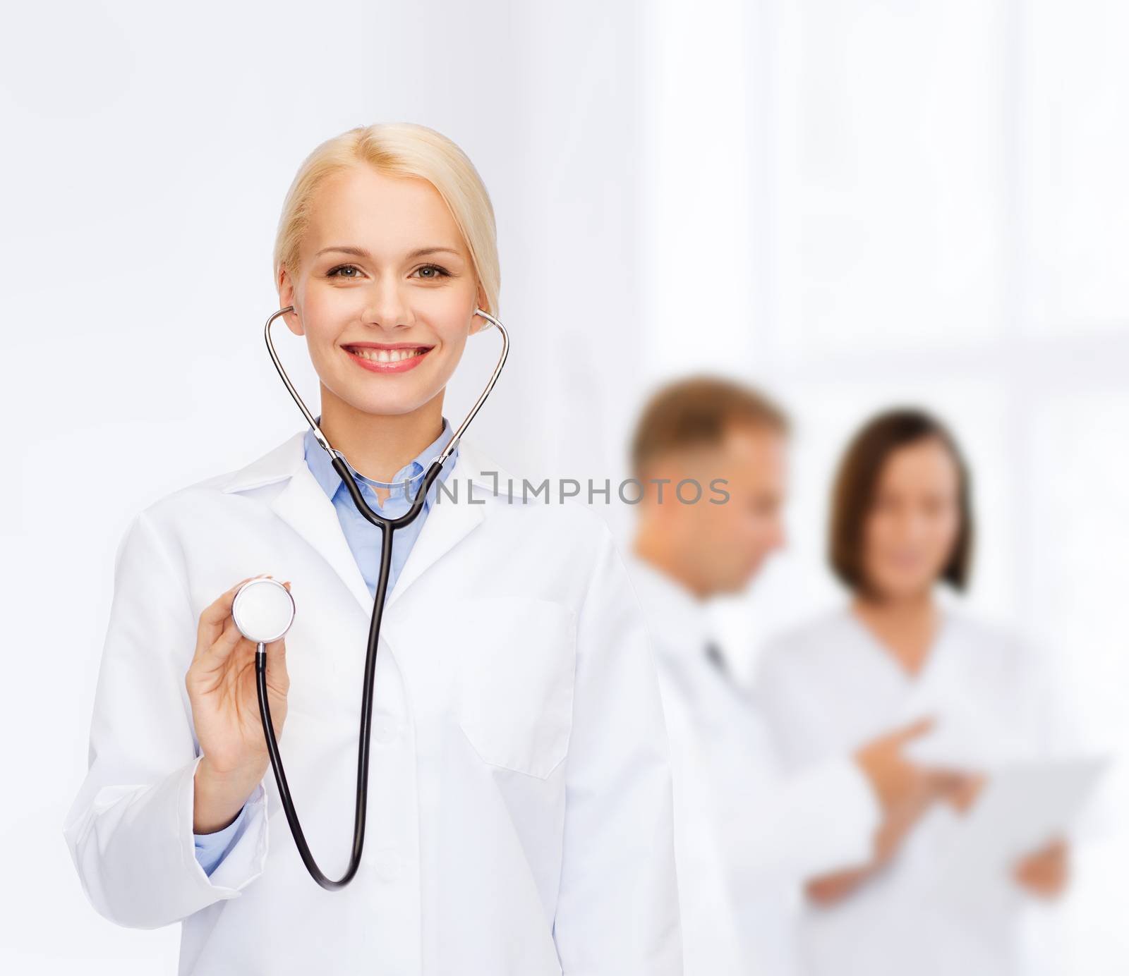 smiling female doctor with stethoscope by dolgachov