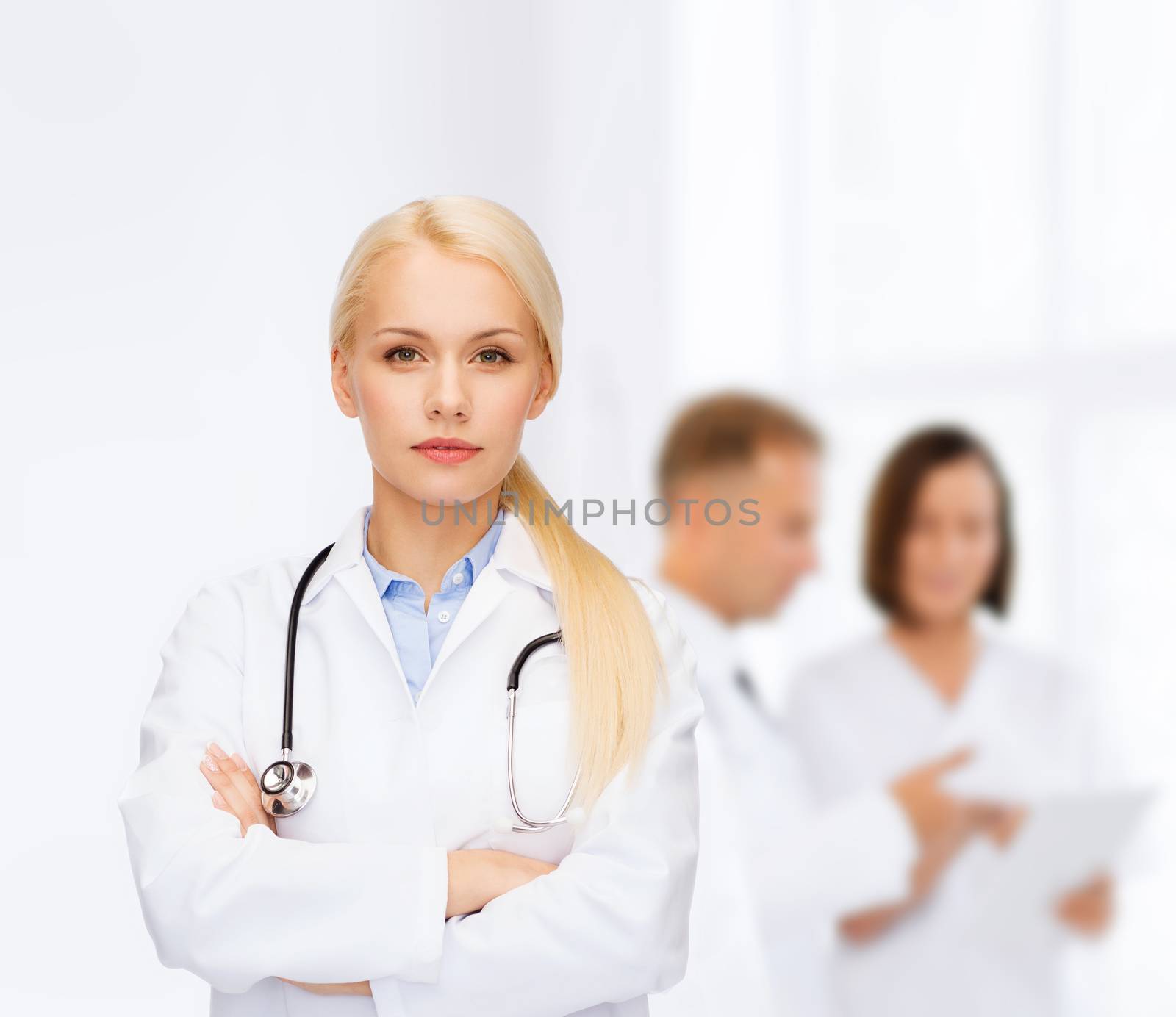 healthcare and medicine concept - serious female doctor with stethoscope