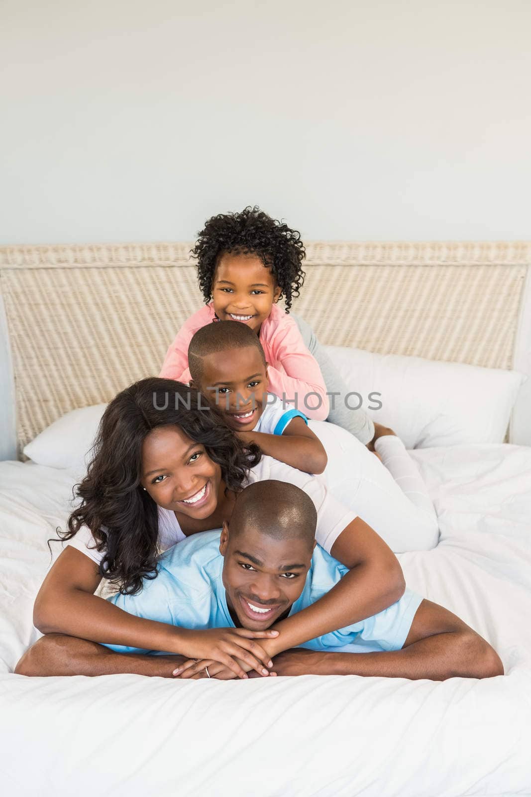 Family having fun together in bed by Wavebreakmedia
