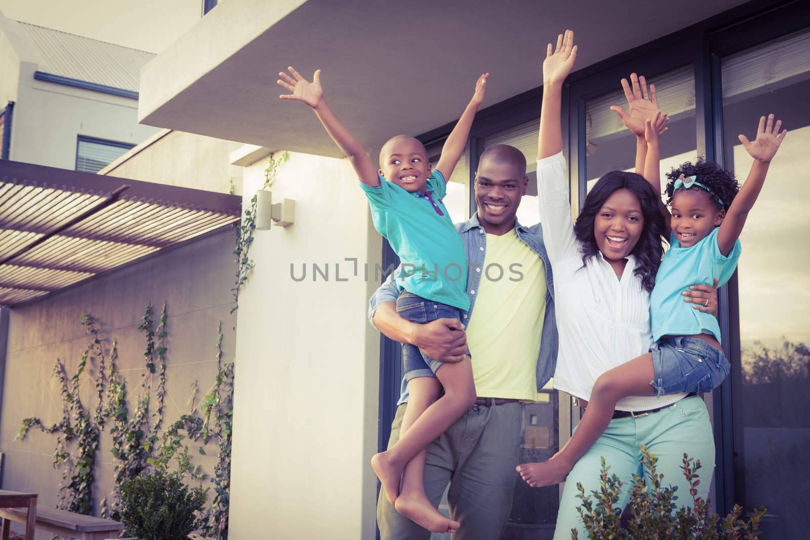 Happy family standing in the garden  by Wavebreakmedia