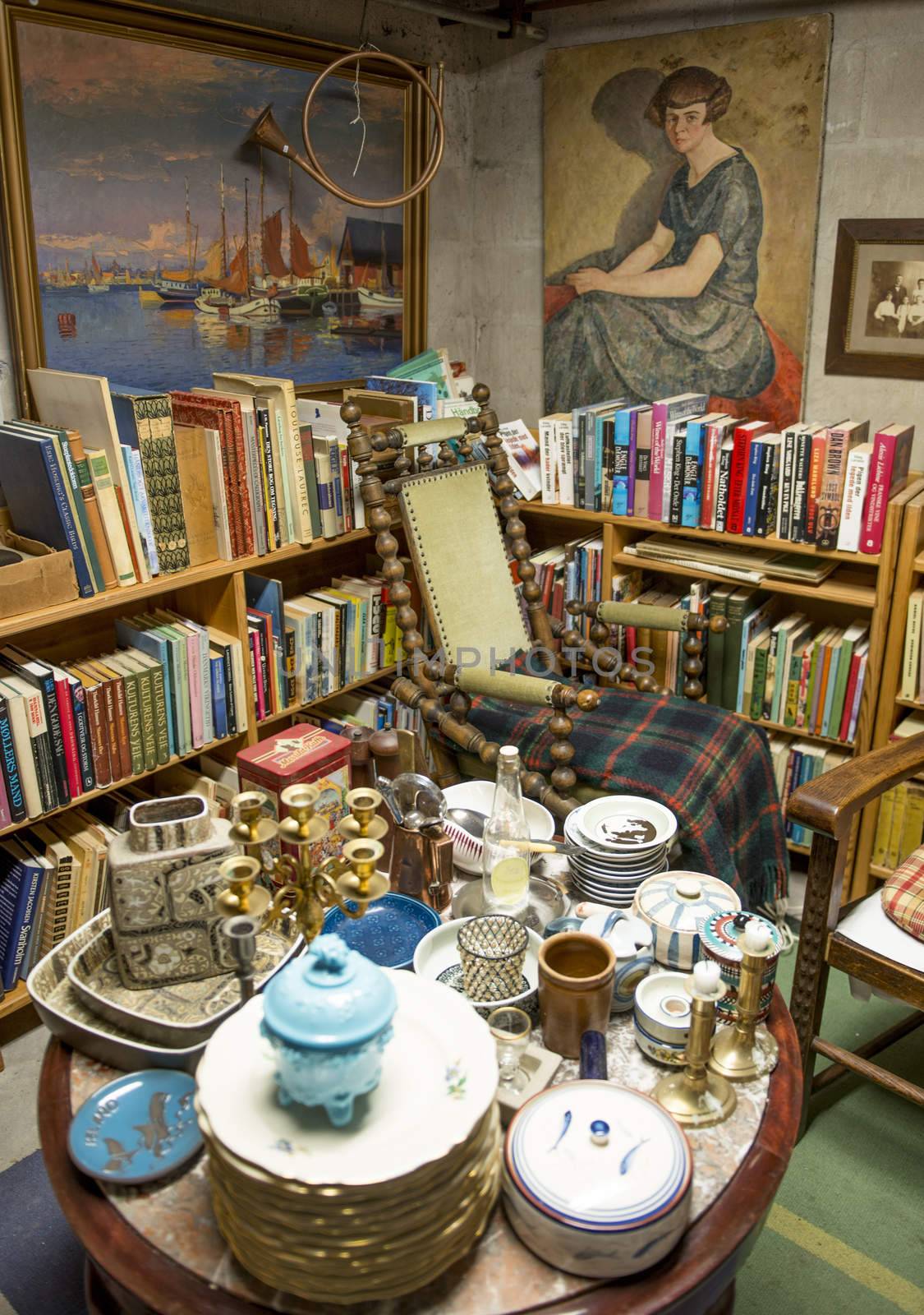 Traditional Antique shop in Denmark. Ceramics, books, pictures and chairs.