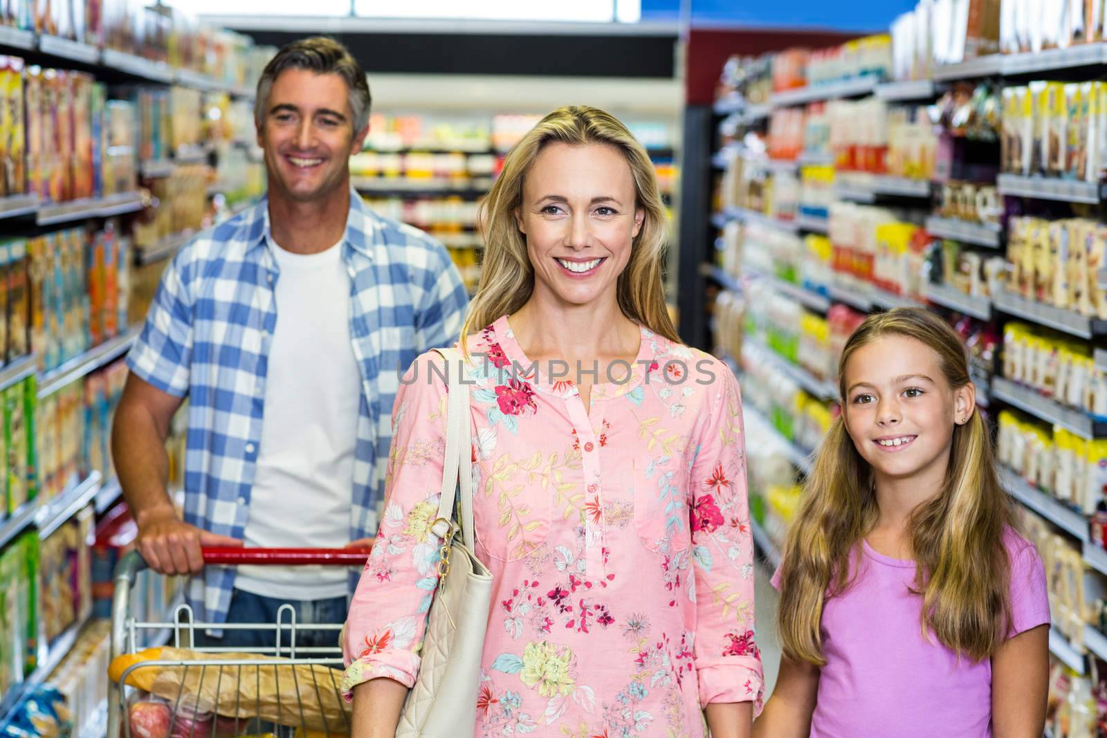 Portrait of happy family in the supermarket