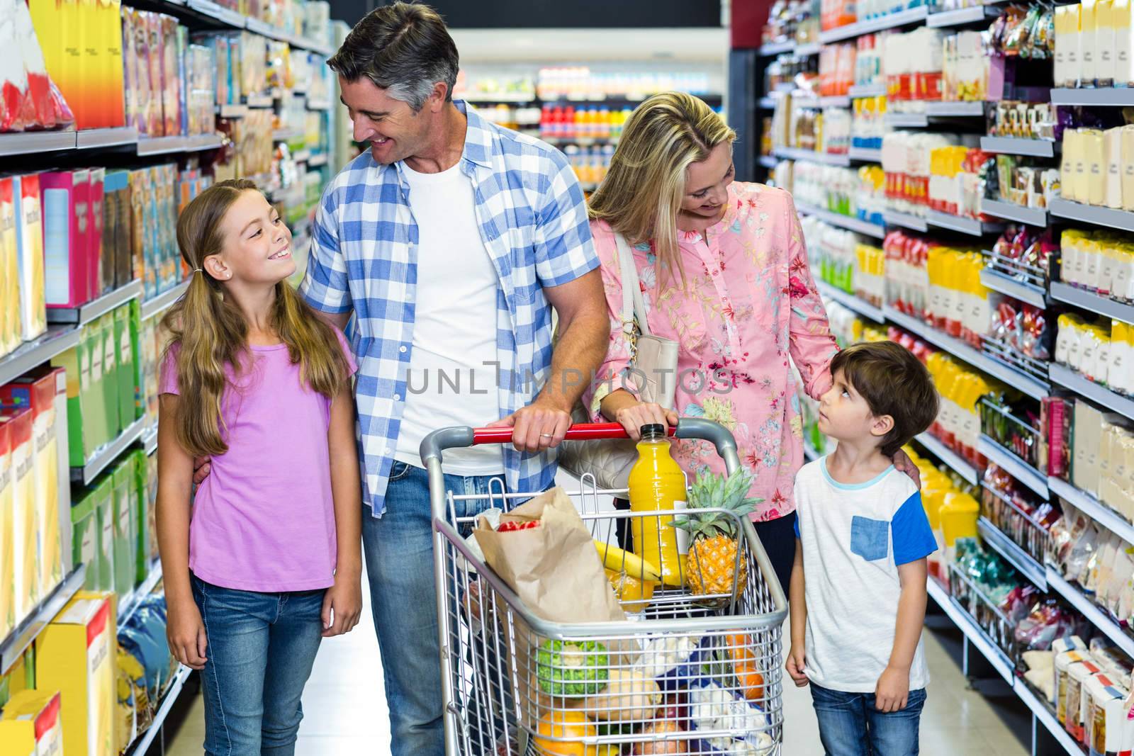 Happy family at the supermarket by Wavebreakmedia