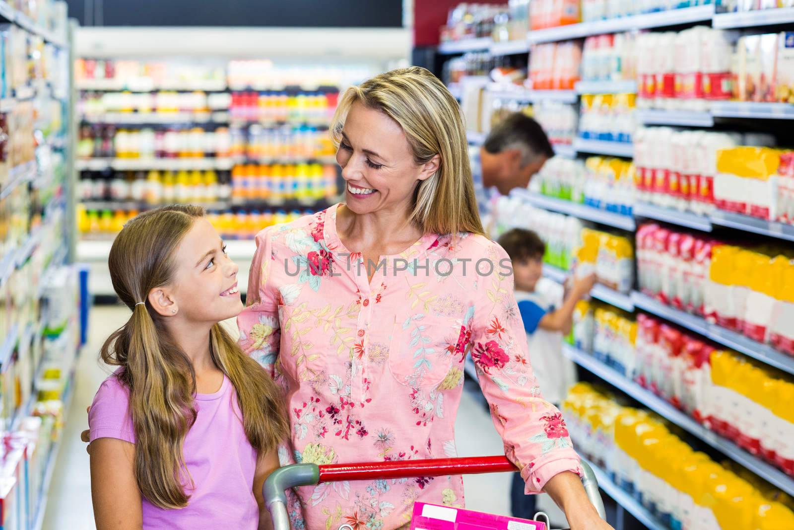 Happy family at the supermarket with cart