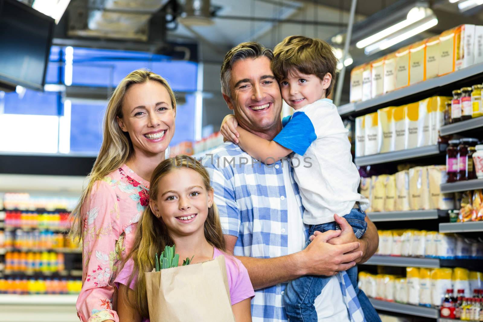 Happy family at the supermarket by Wavebreakmedia