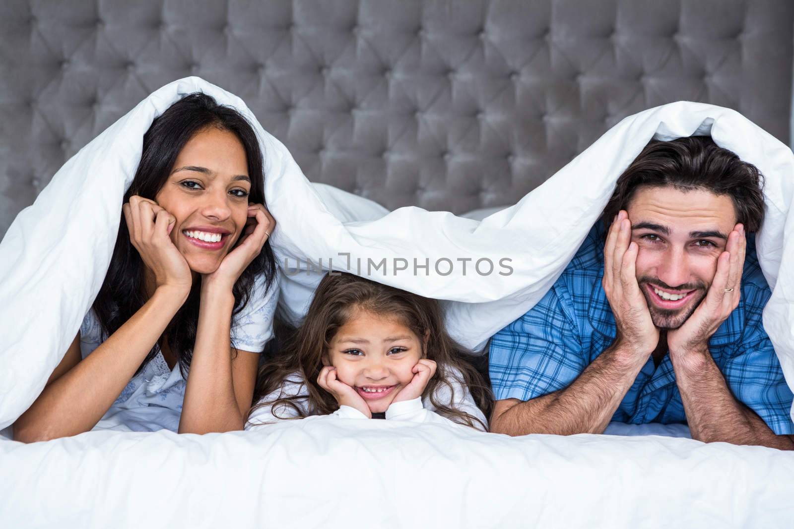 Happy family posing for camera by Wavebreakmedia