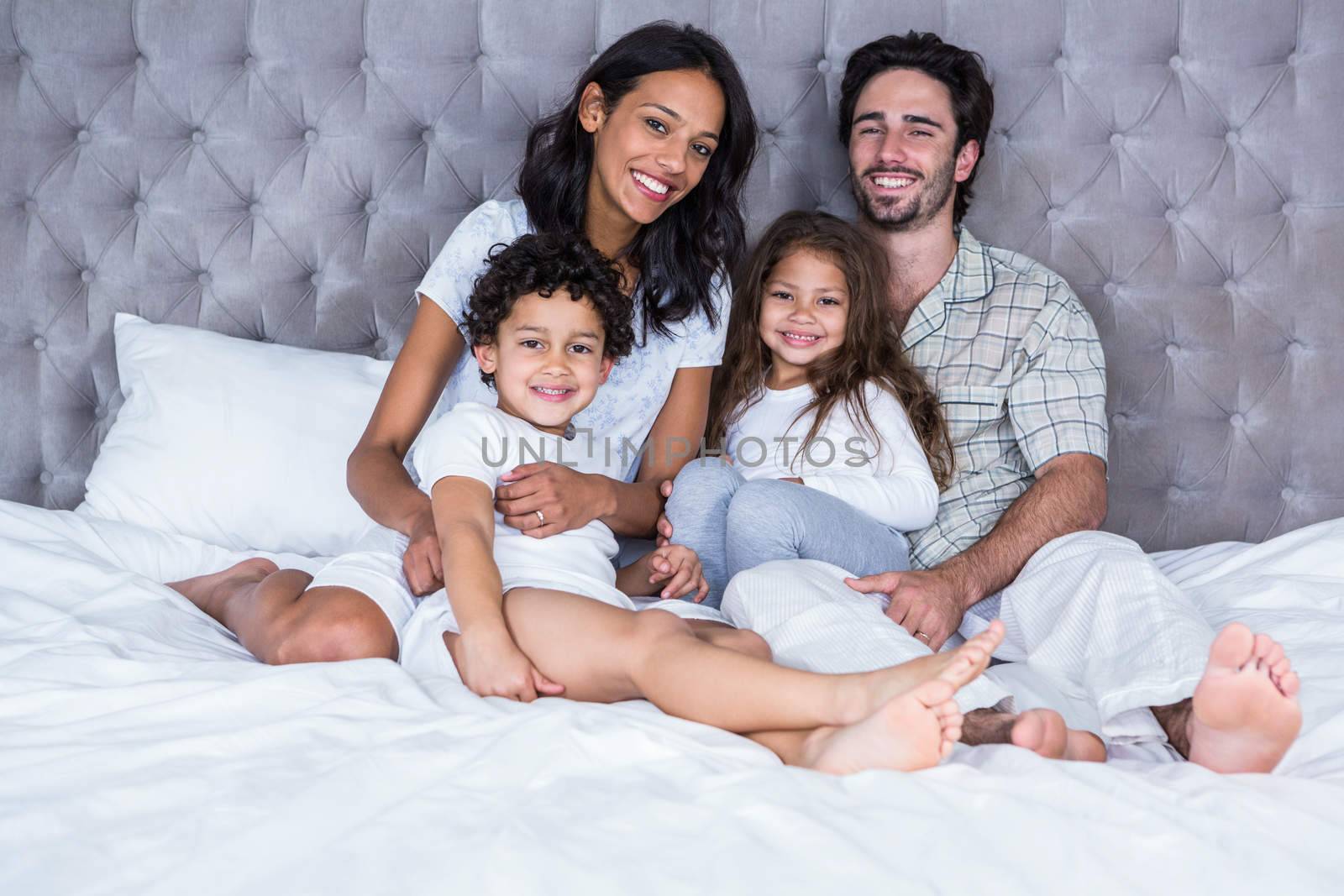 Happy family on the bed by Wavebreakmedia