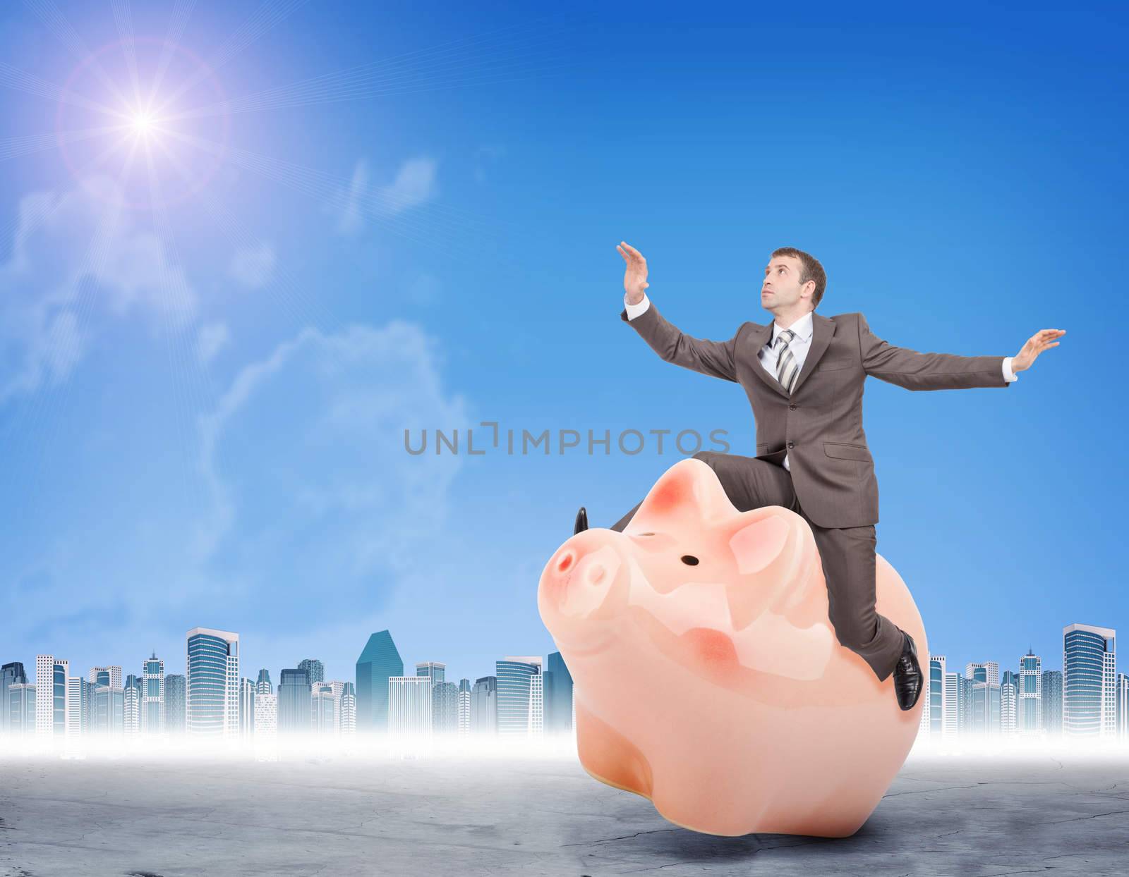 Businessman sitting on piggy bank on nature background