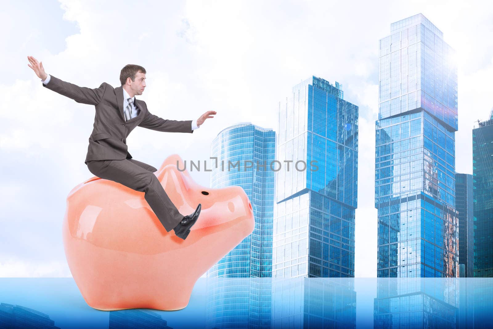 Businessman sitting on piggy bank on city background