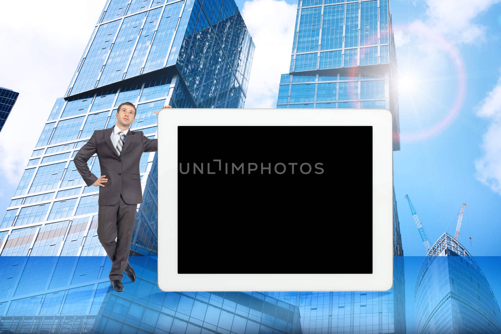 Businessman and big tablet with blank screen, front view