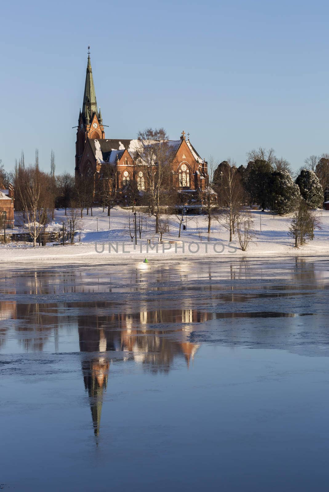 Church in Umeå, Sweden with clear blue sky and some ice on the river.