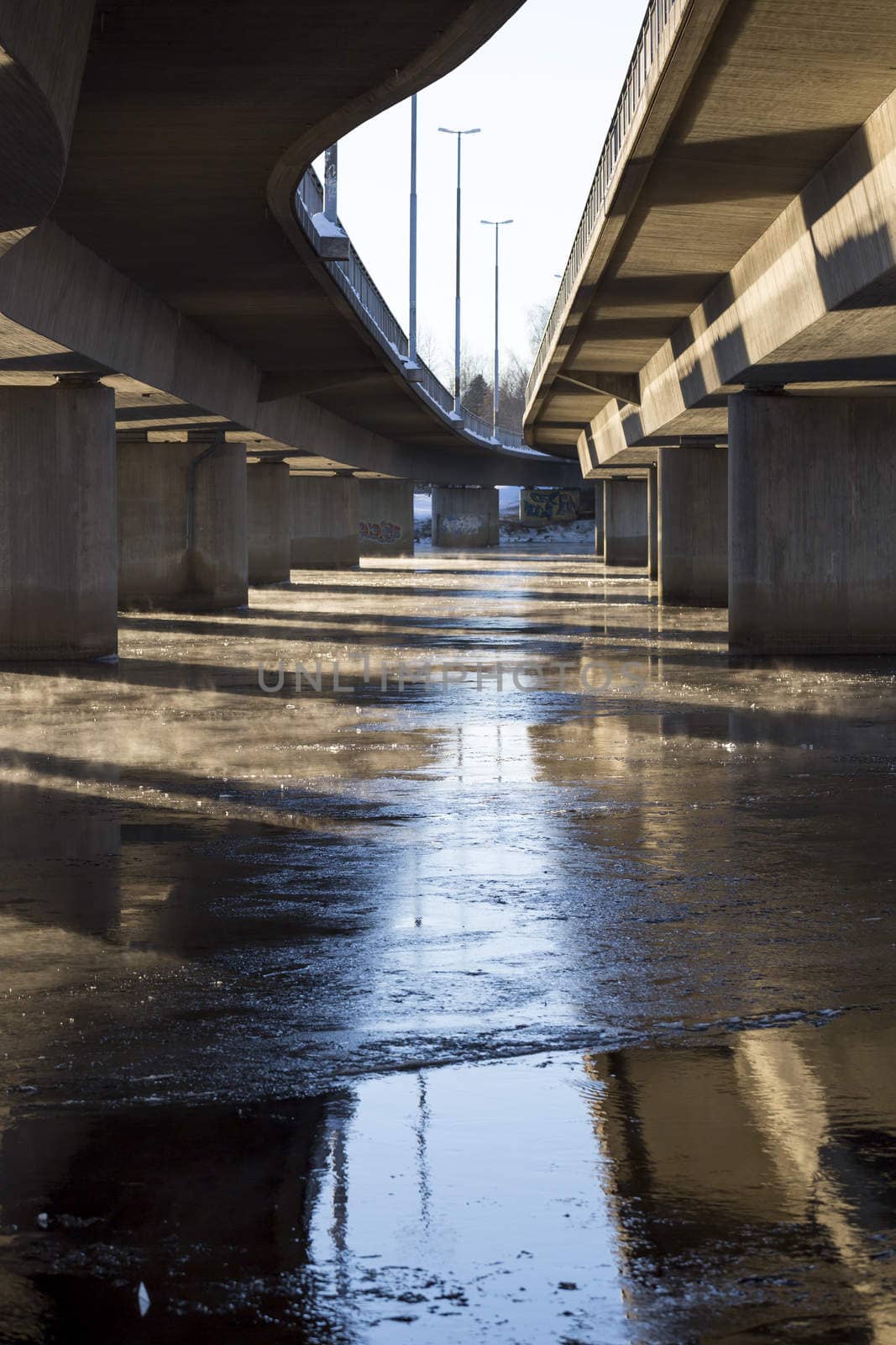 Mist on Icy River under Bridge in Umea, Sweden