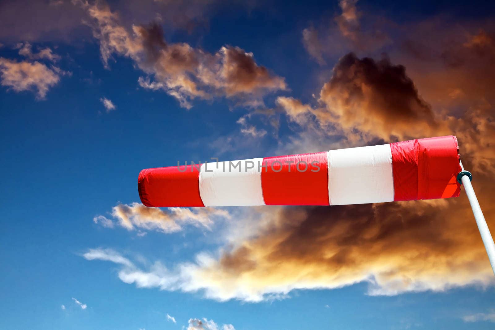 horizontally flying windsock against stormy clouds