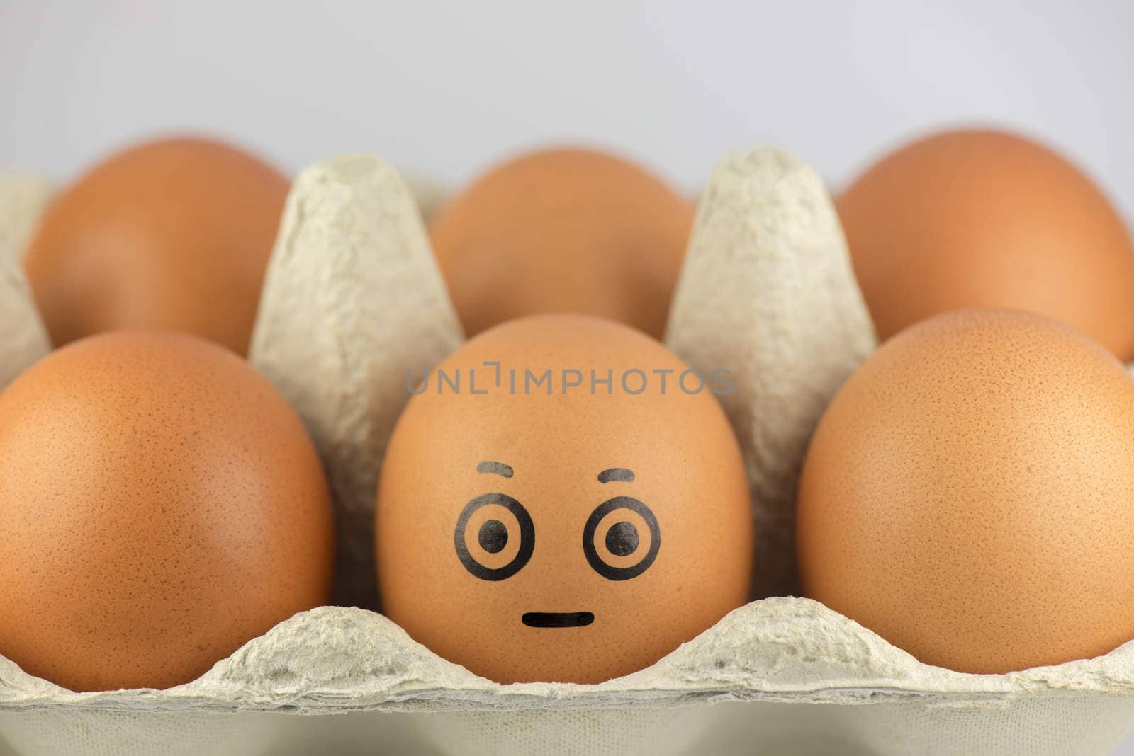 Egg with a face in a egg carton
