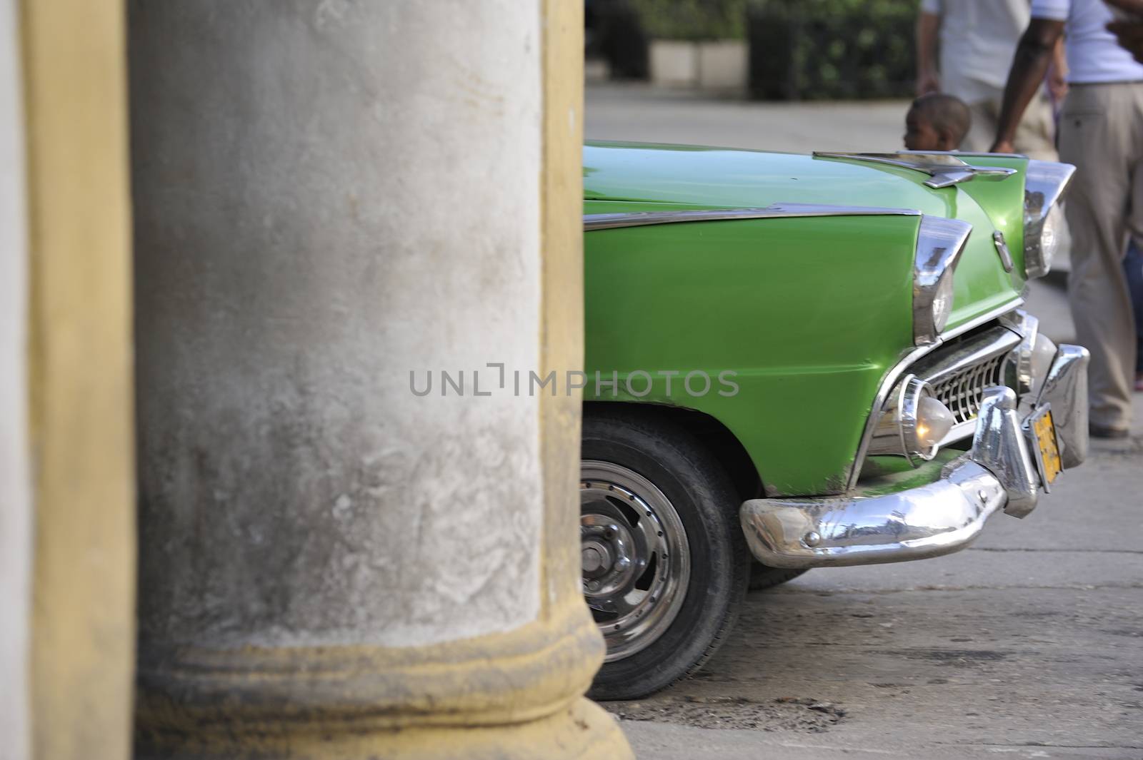 Old Havana, Cuba, -  August  2013. The old vintage-styled car in the historical center of Havana is waiting for the tourists to board. Riding an auto of the 20's - 50's is one of the attractions for the tourists in Cuba. Such cars are used for any goal, not only tourism, but taxis and personal needs.