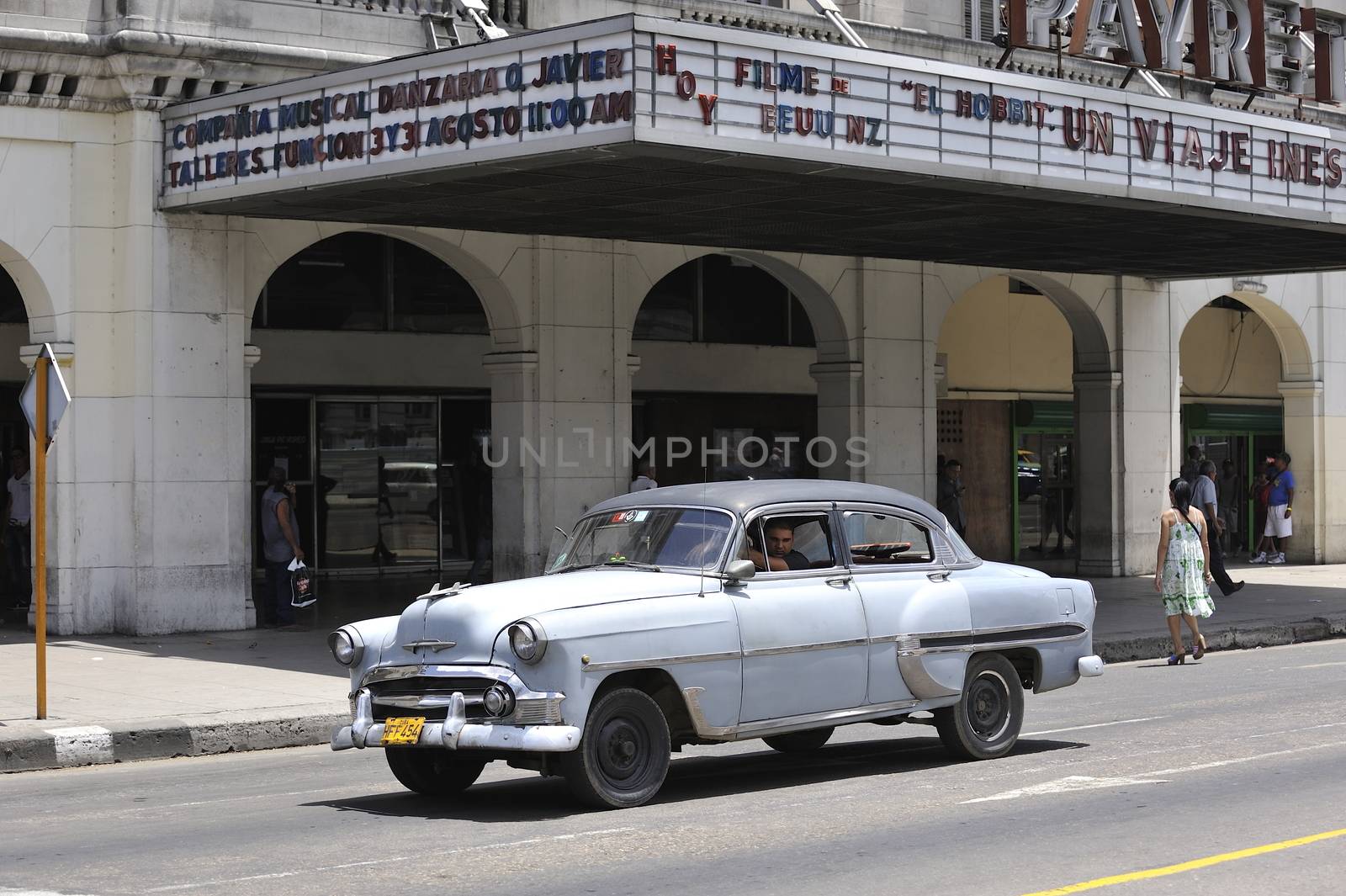 Old Havana, Cuba, -  August  2013. The old vintage-styled car in the historical center of Havana is waiting for the tourists to board. Riding an auto of the 20's - 50's is one of the attractions for the tourists in Cuba. Such cars are used for any goal, not only tourism, but taxis and personal needs.