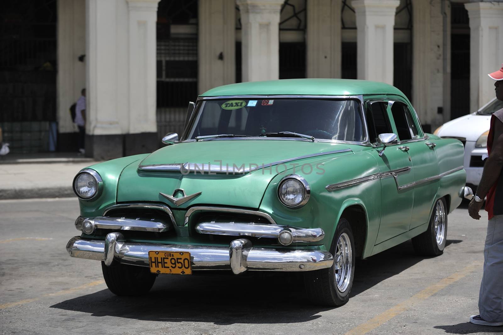 Old Havana, Cuba, -  August  2013. The old vintage-styled car in the historical center of Havana is waiting for the tourists to board. Riding an auto of the 20's - 50's is one of the attractions for the tourists in Cuba. Such cars are used for any goal, not only tourism, but taxis and personal needs.