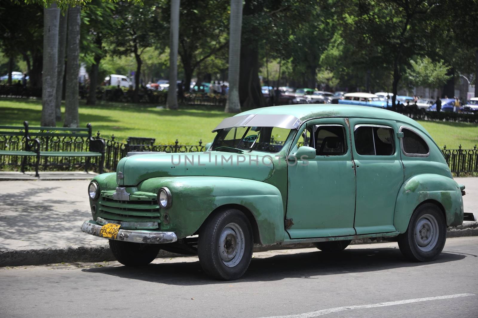 Old Havana, Cuba, -  August  2013. The old vintage-styled car in the historical center of Havana is waiting for the tourists to board. Riding an auto of the 20's - 50's is one of the attractions for the tourists in Cuba. Such cars are used for any goal, not only tourism, but taxis and personal needs.