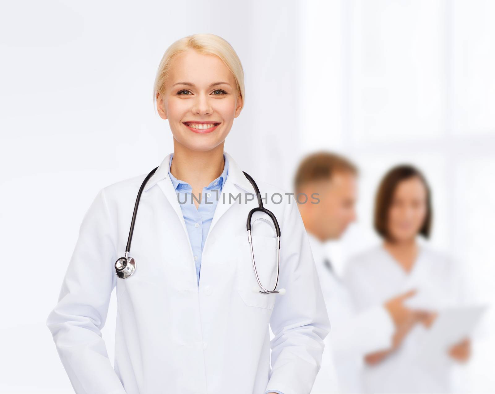 smiling female doctor with stethoscope by dolgachov