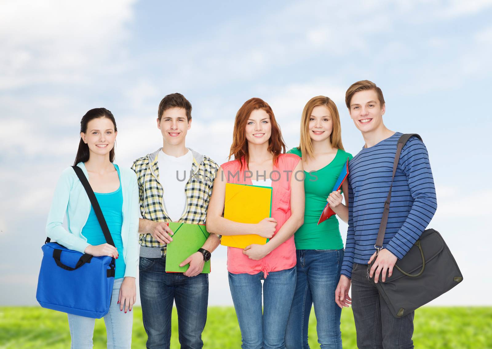 education and people concept - group of smiling students standing