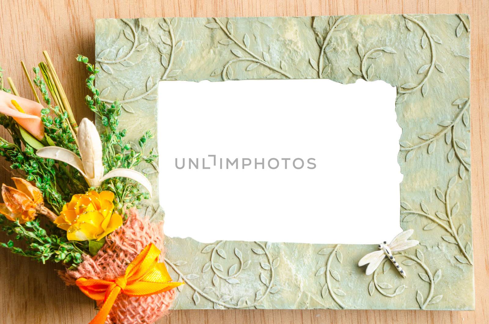 Blank photo frame and pink rose on wooden background. save clipping path.