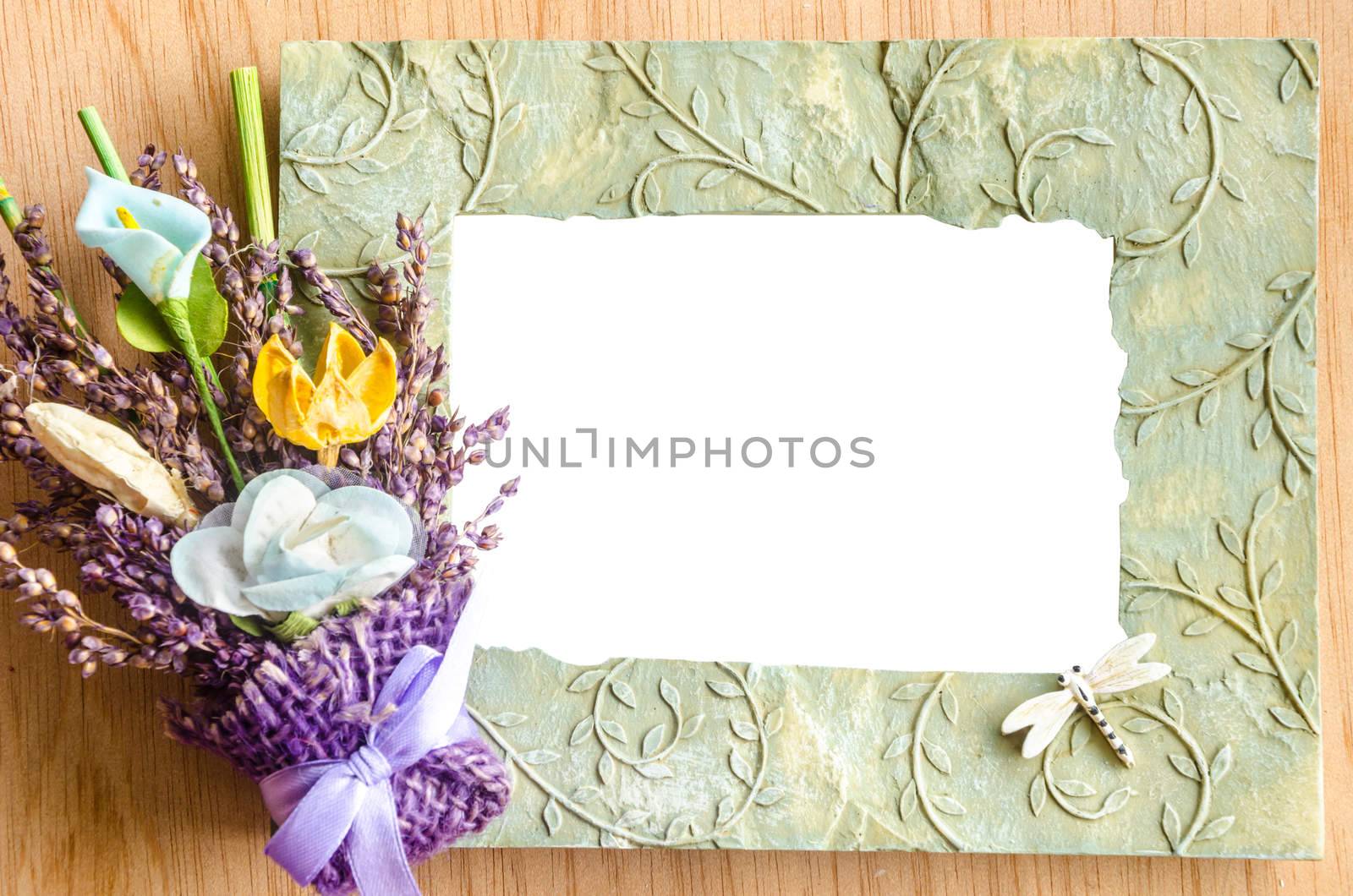Blank photo frame and pink rose on wooden background. save clipping path.