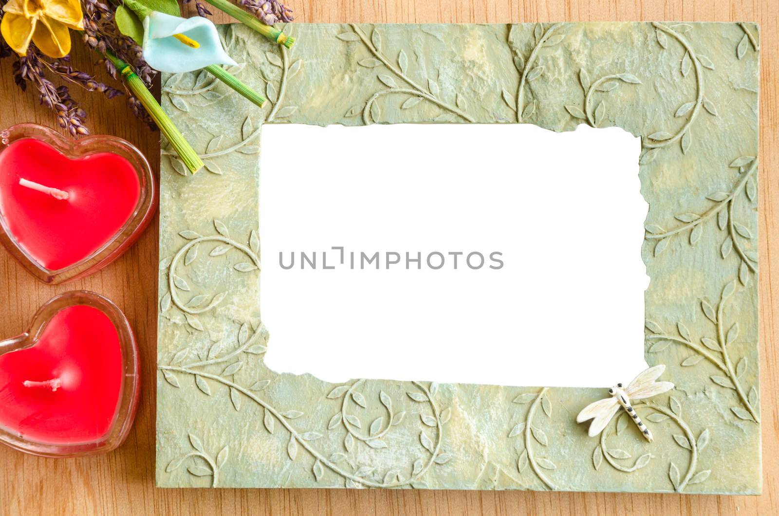 Blank photo frame and pink rose on wooden background. save clipping path.