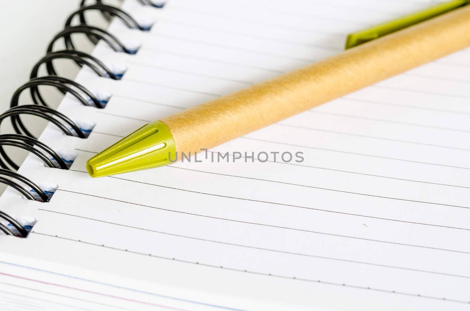 Open notebook and pen on white background.