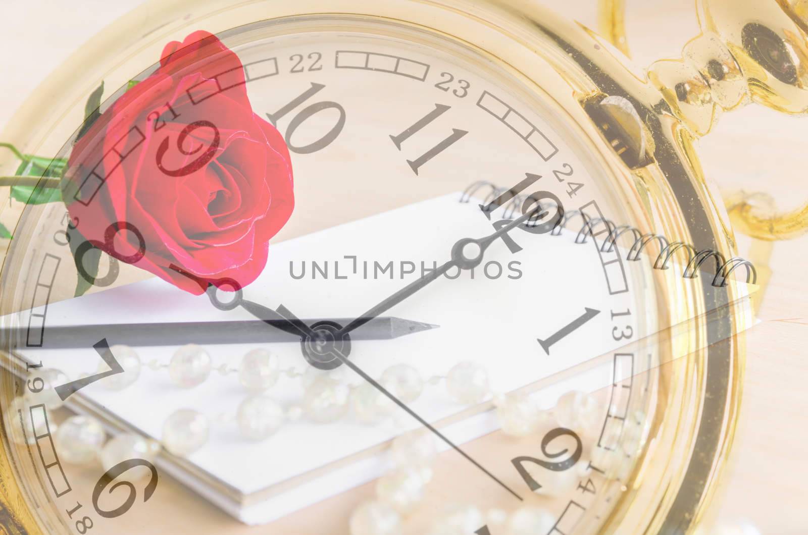 Vintage gold pocket watch with red rose and blank diary background. Time of love concept.