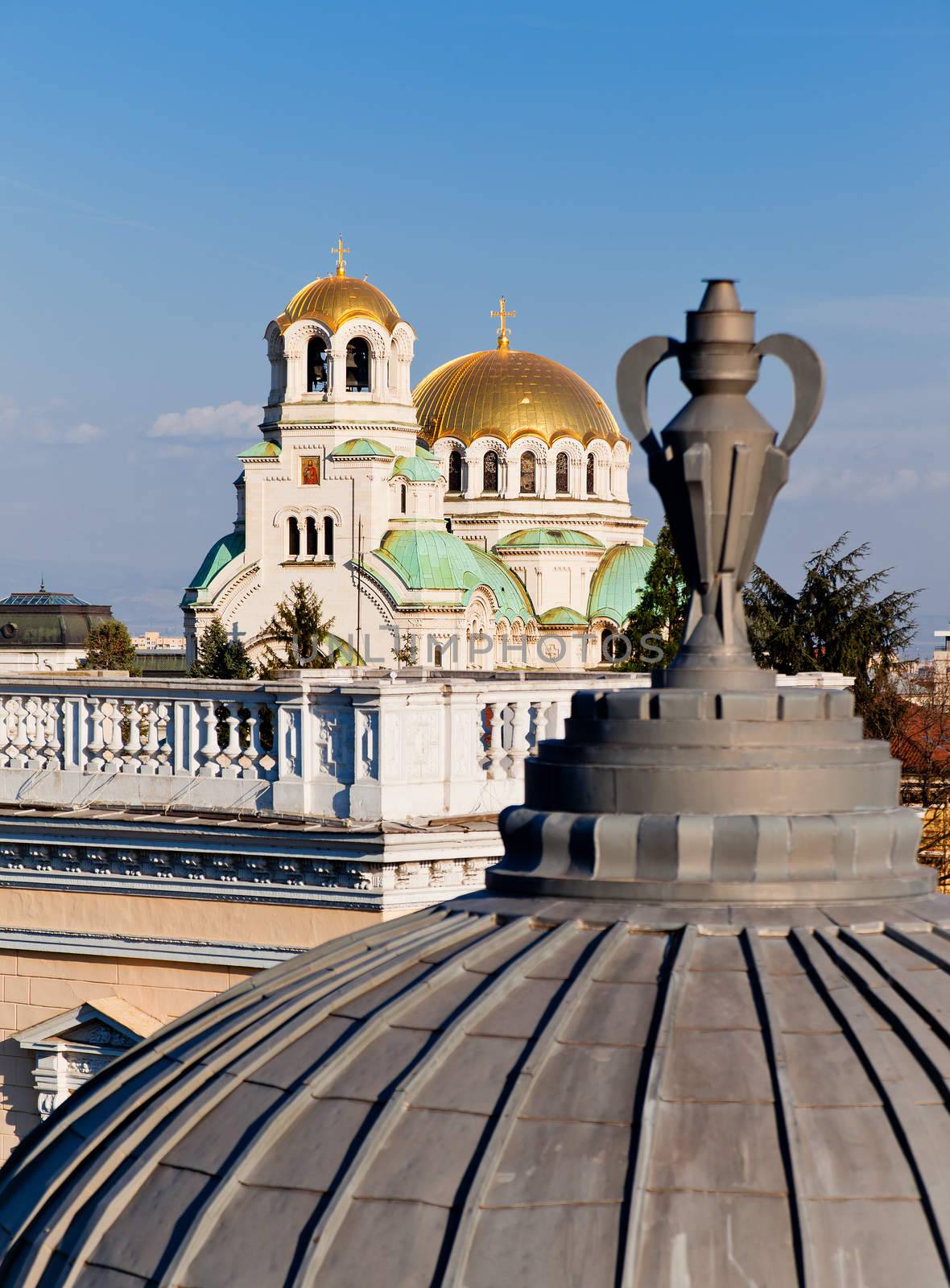 A view of golden domes st. Aleksander Nevski cathedral in Sofia, Bulgaria through a detail on a roof of a building. Vertical image.