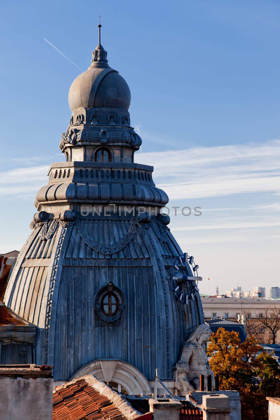 A detail with statue and a clock of an old building in the center of Sofia, Bulgaria, Europe.