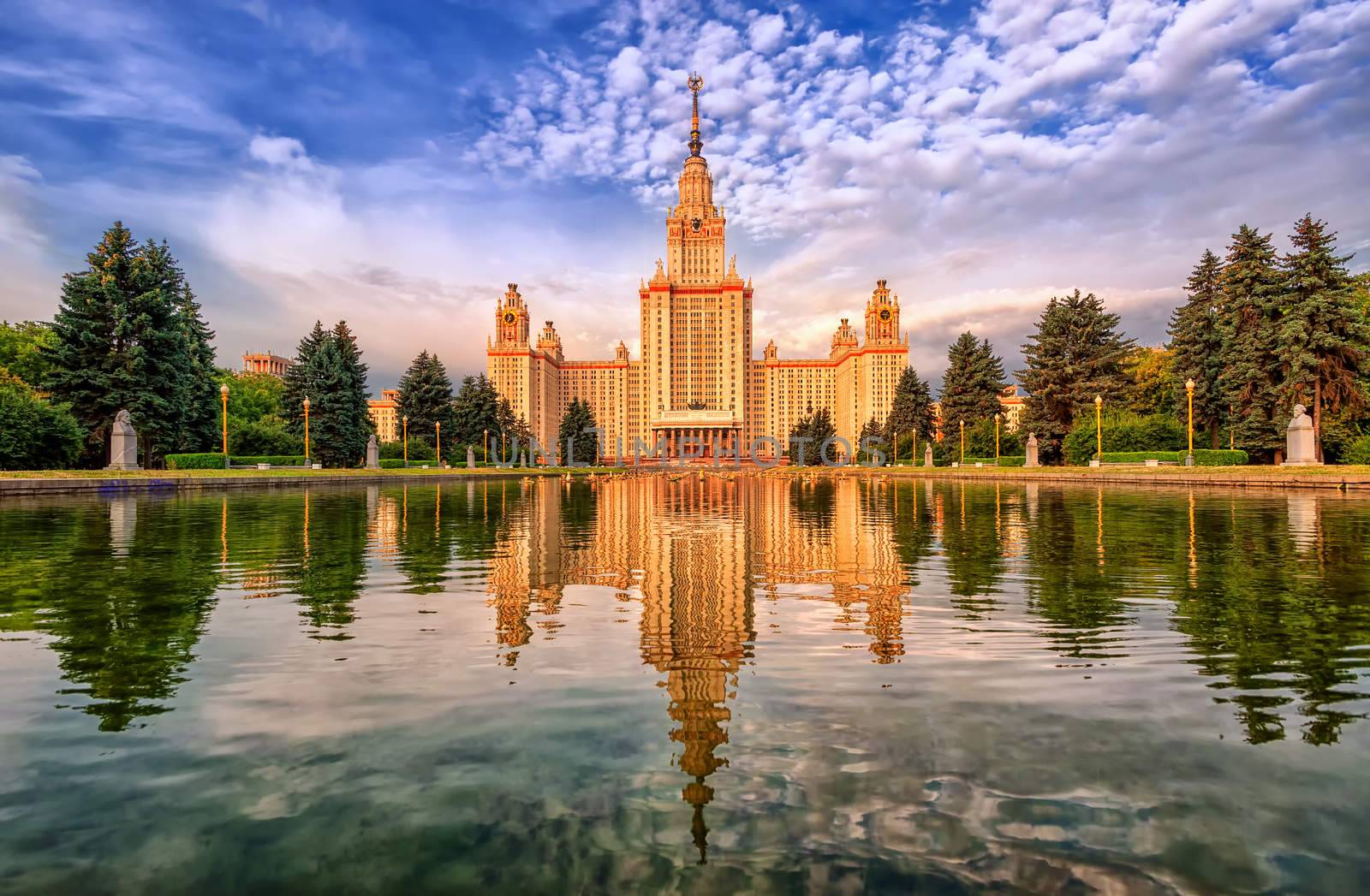 Neoclassical Moscow State University (MGU) building on Vorobyevy Gory, reflecting in lake, Russia