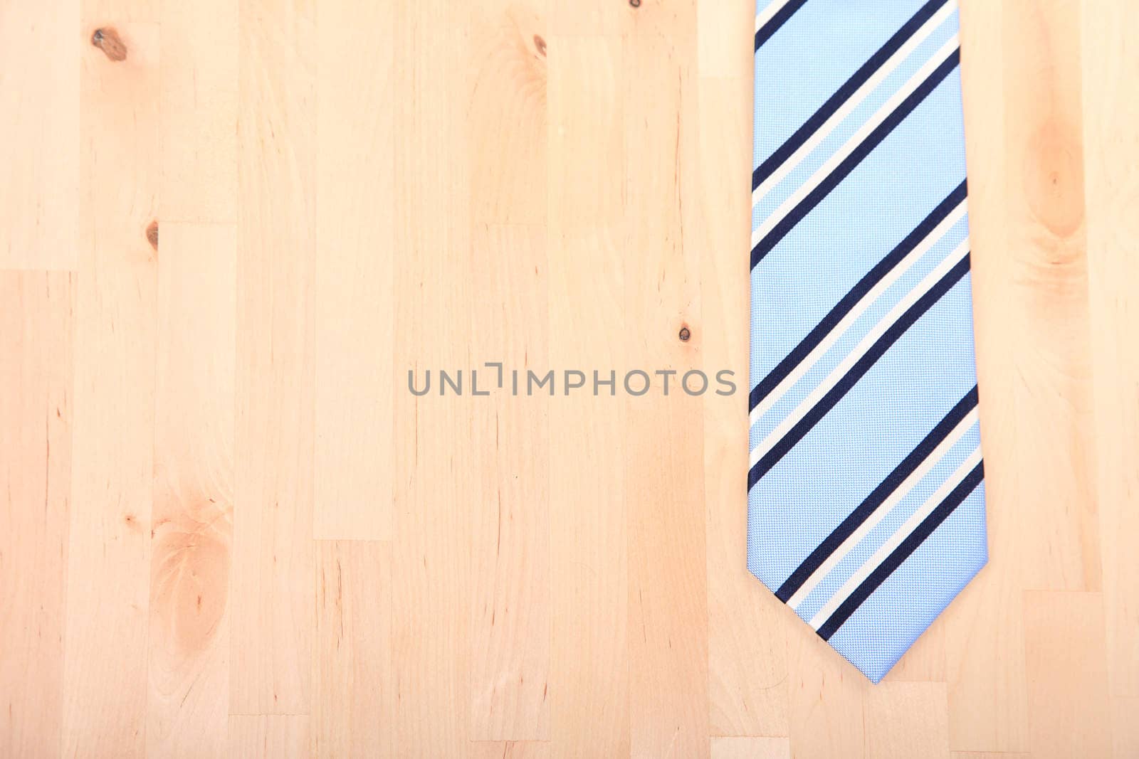 Striped business tie on wooden background