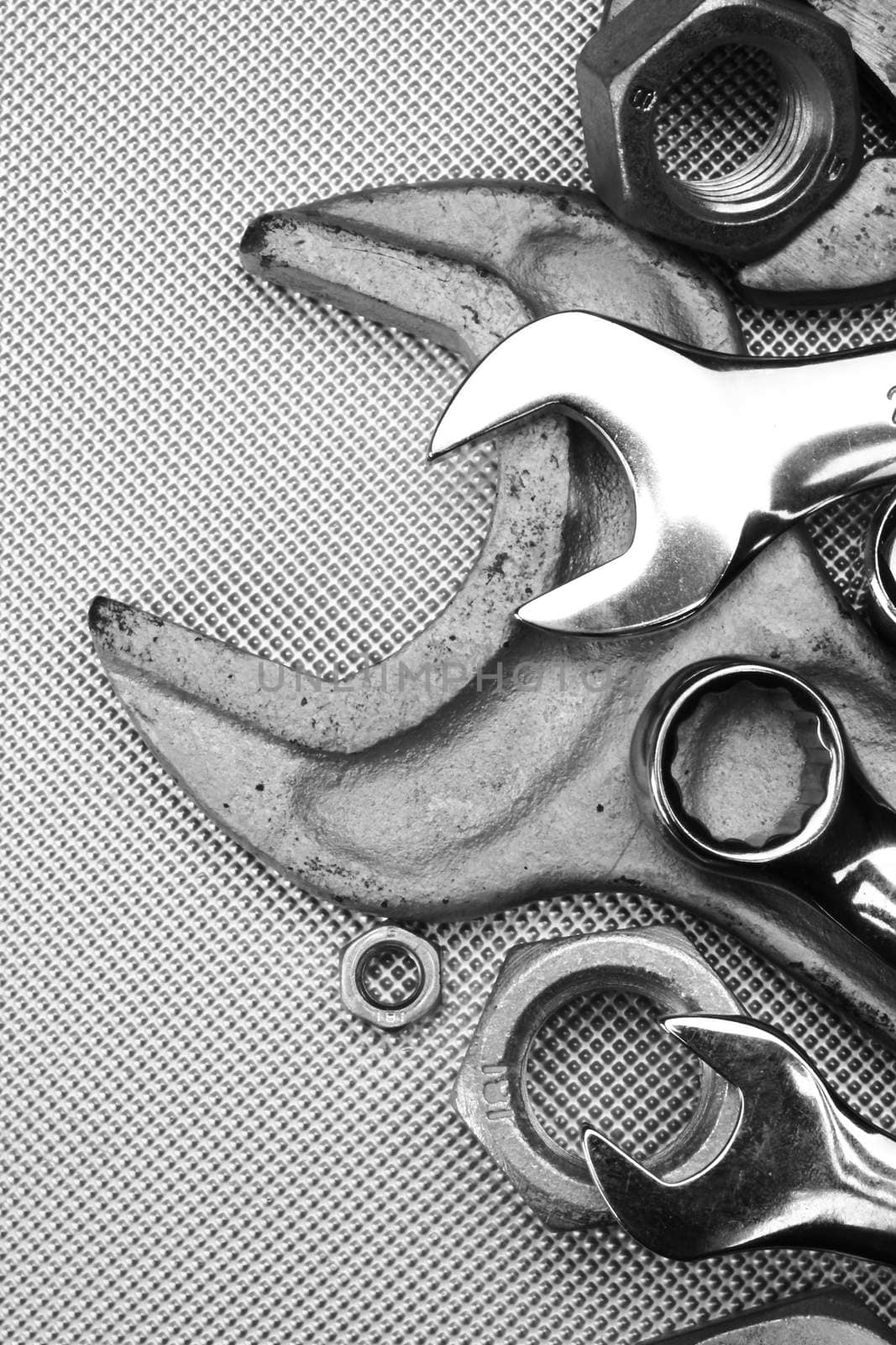 Some wrenches and nuts black and white