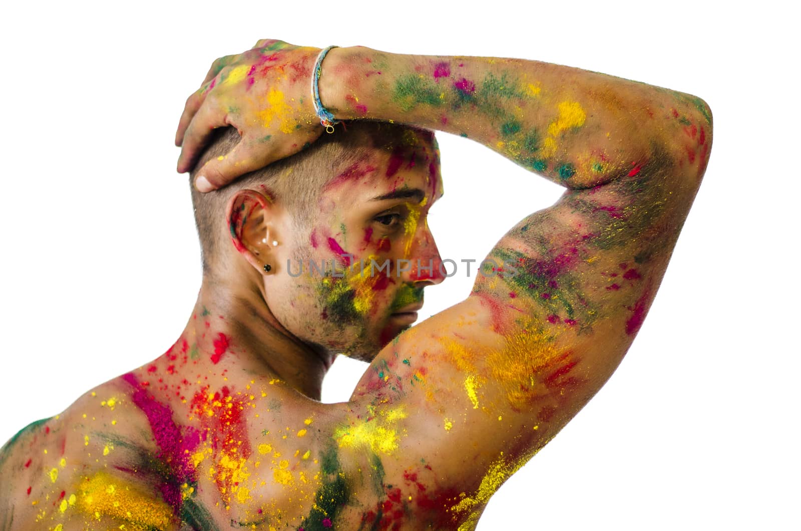 Back of shirtless young man, skin painted all over with bright Holi colors by artofphoto
