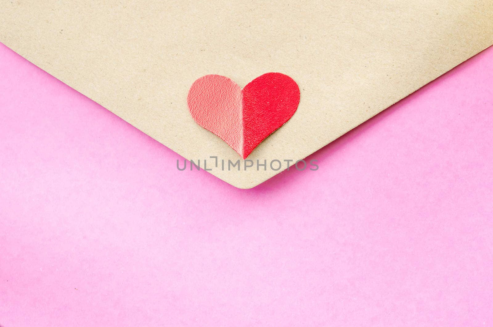 Close up pink and brown letter with red heart.