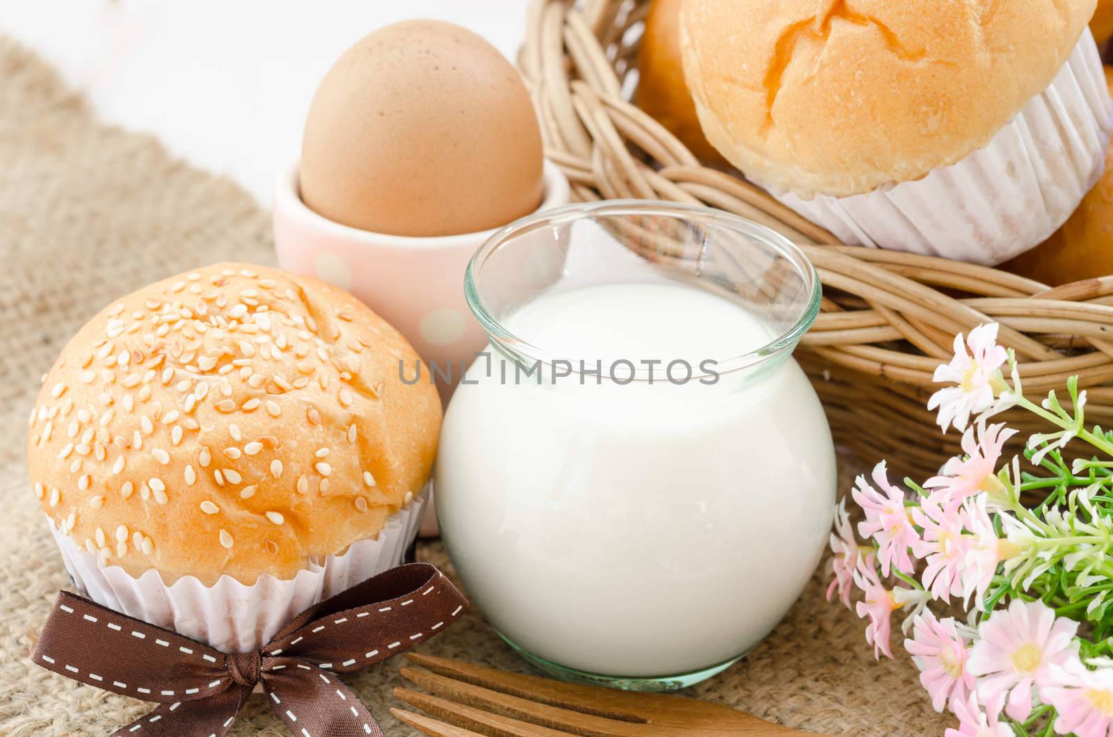 bread bun with white sesame and milk on sack background.