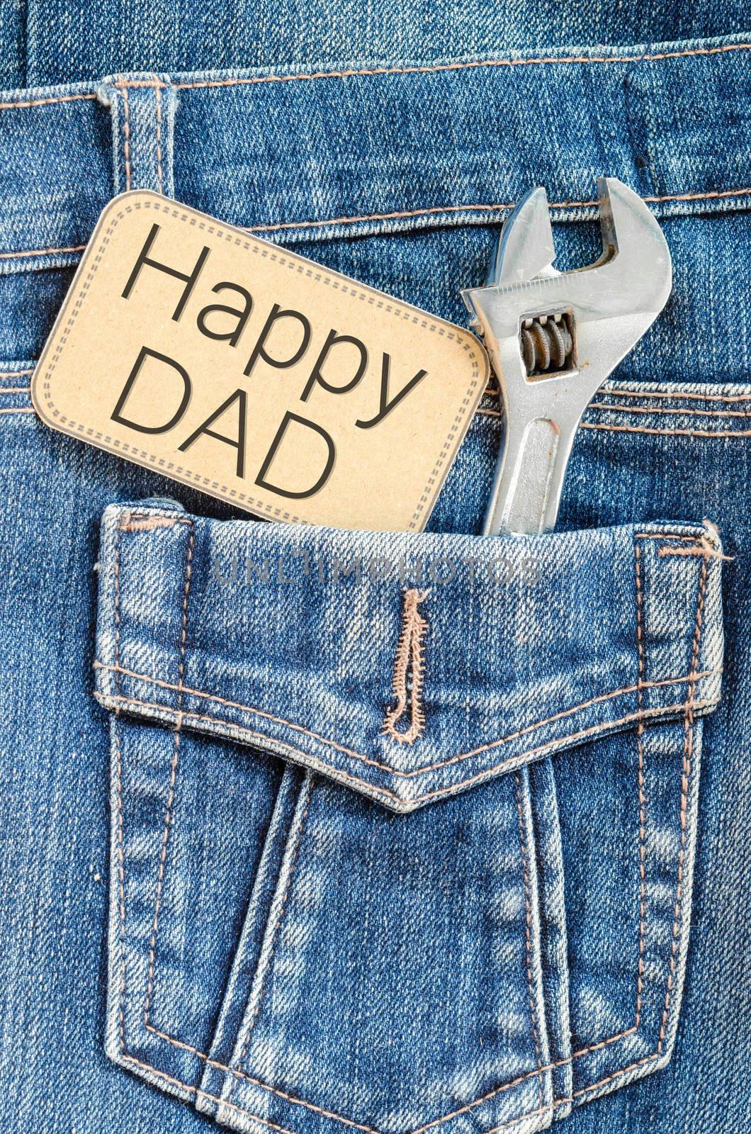 Closeup father's day card love dad or daddy or papa in pocket jeans -- Happy Labor Day on blackboard with tool steel iron wrench silver chrome. holiday for worker.