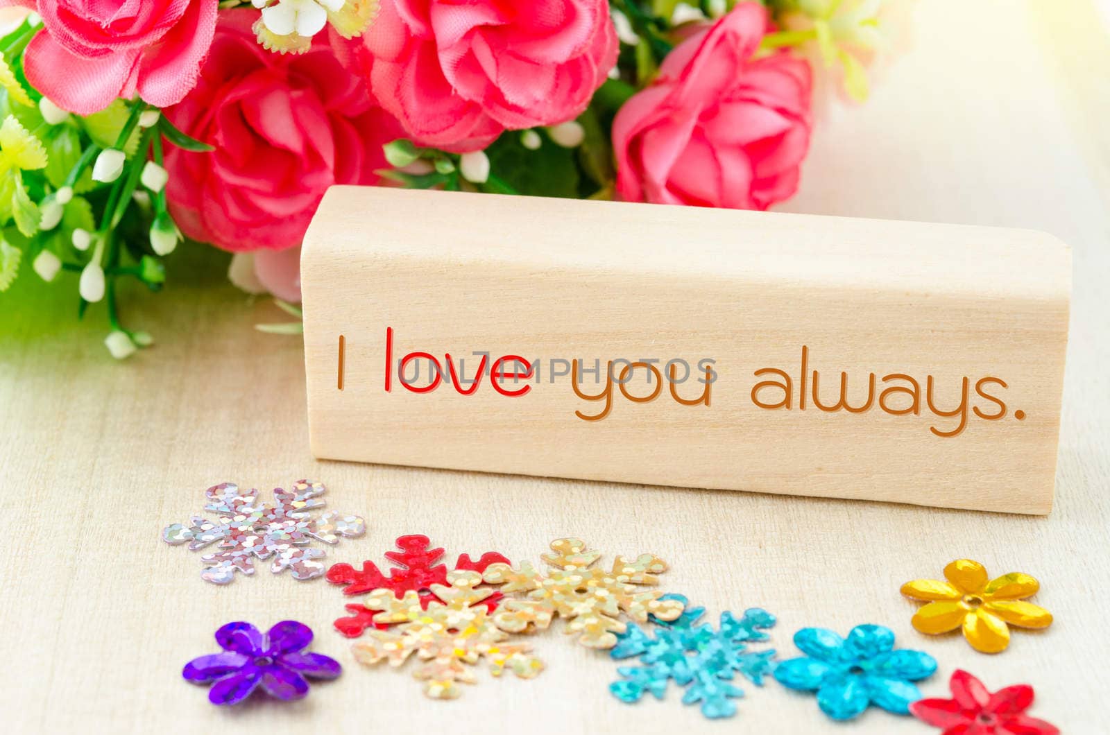 I love you always On wooden tag and ping rose on wooden background.