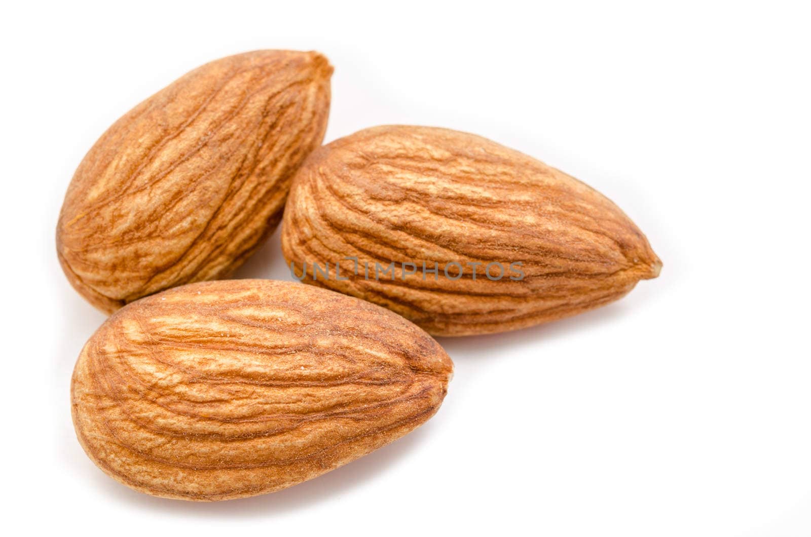 Close up raw almonds isolated on white background.