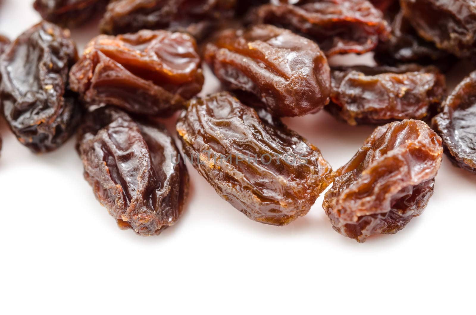 Close up Pile of Raisins on white background.