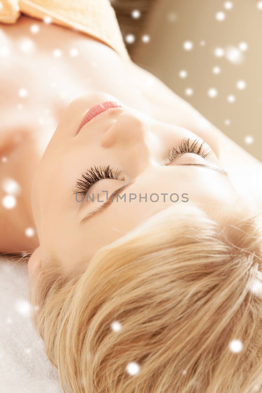 beauty, health, people and spa concept - beautiful young woman in spa