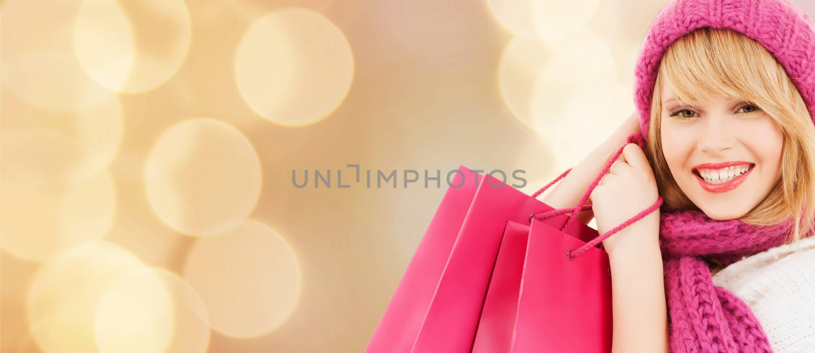 smiling young woman with shopping bags by dolgachov