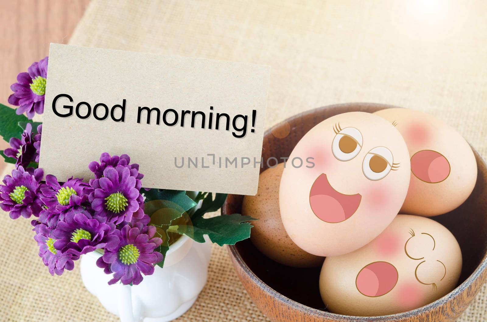 Good morning card and smile face eggs in wooden bowl on woden background.