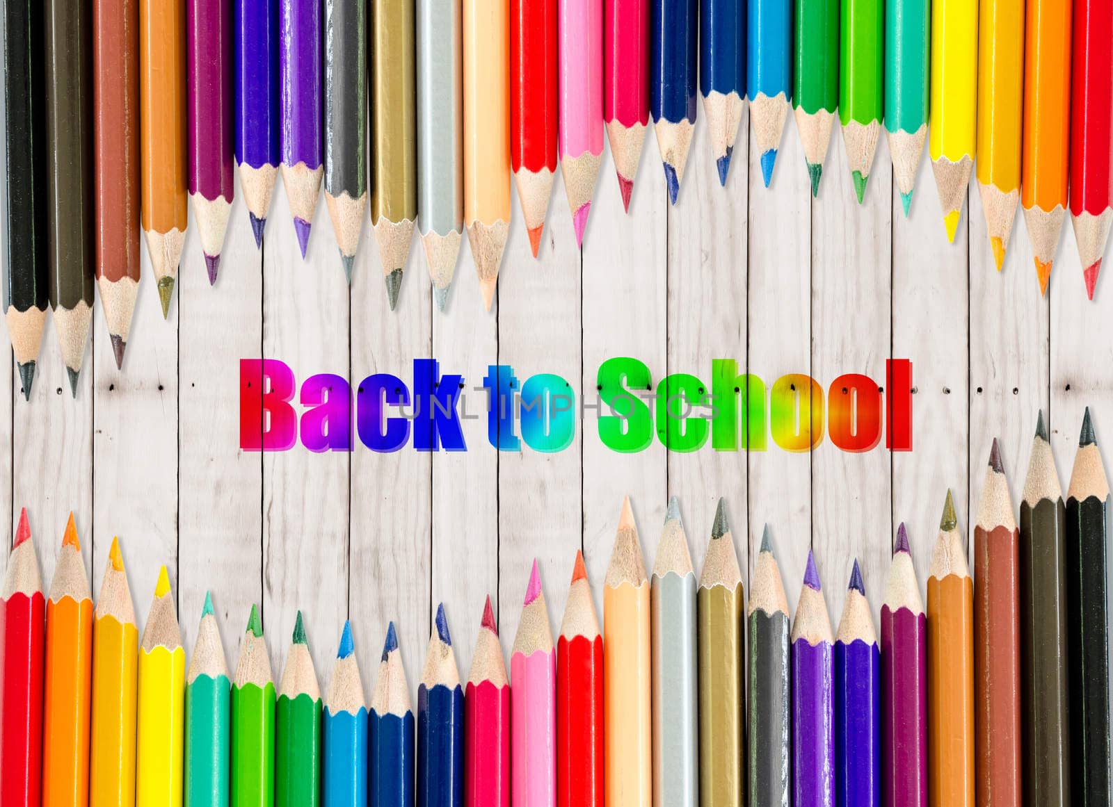 back to school - frame of multicolored pensils on wooden background