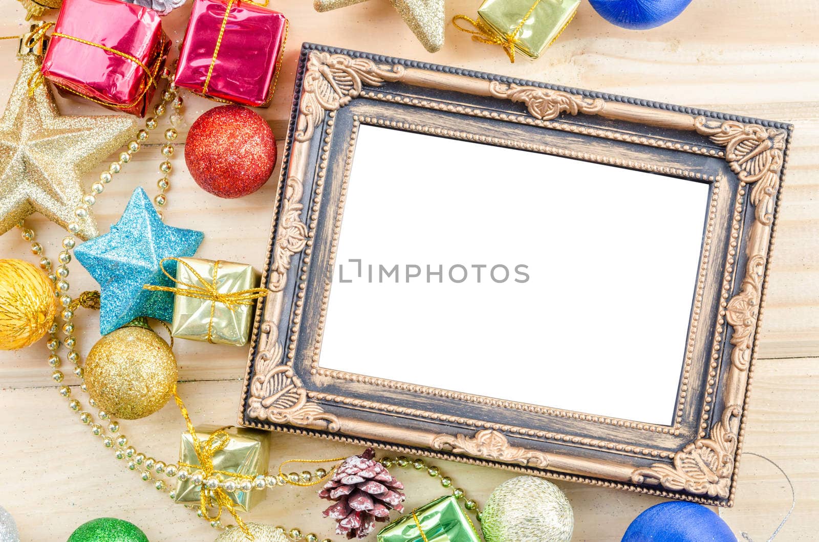 Vintage blank photo frame with chirstmas decorations on wood background. Save clipping path.