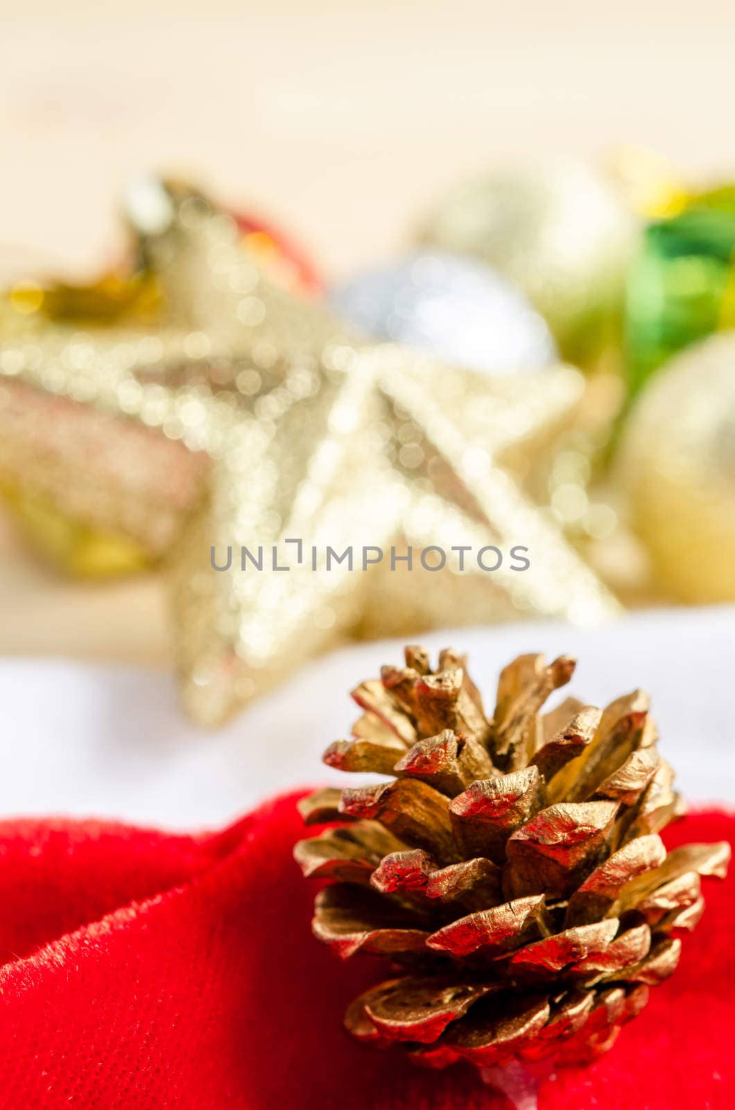 Close up gold pine cones with christmas decorations. by Gamjai